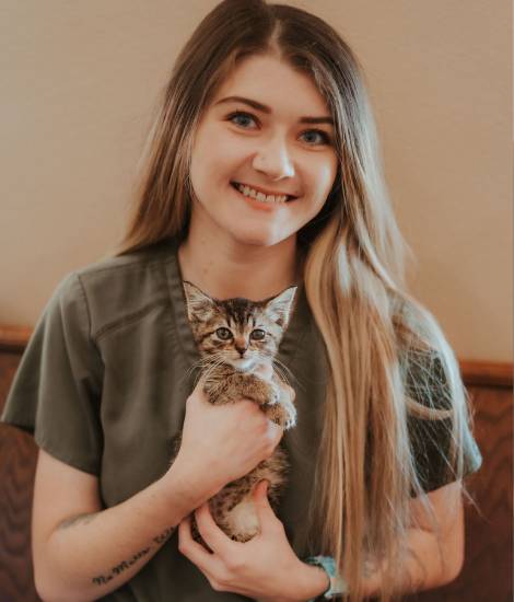 staff holding a pet smiling