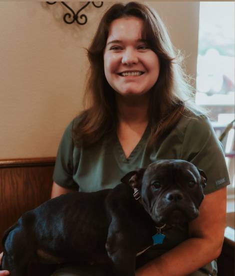 staff holding a pet smiling