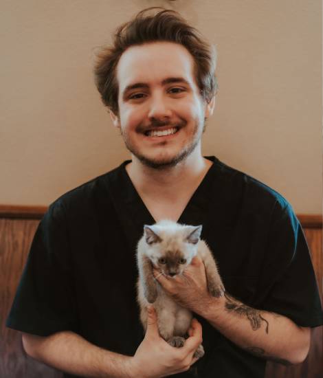 staff holding a pet with smile