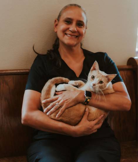 staff holding a pet smiling
