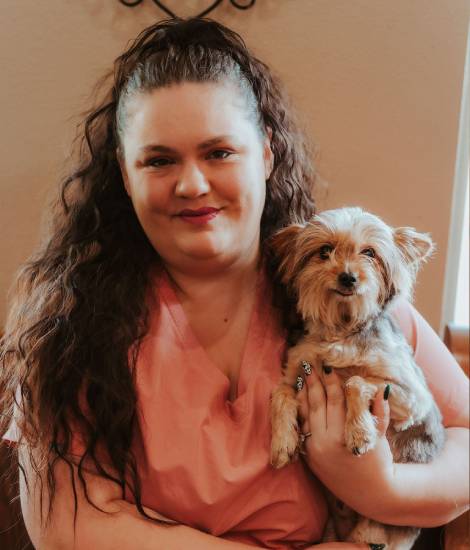 staff holding a pet smiling