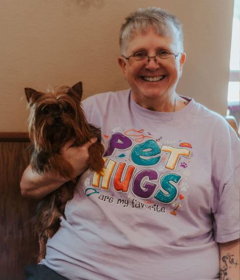 staff holding a pet smiling